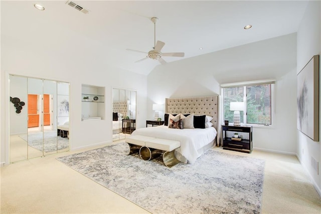 bedroom featuring ceiling fan, high vaulted ceiling, and light carpet