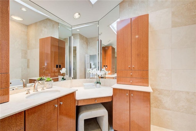 bathroom with vanity and tile walls