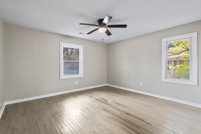 unfurnished room with hardwood / wood-style flooring and ceiling fan