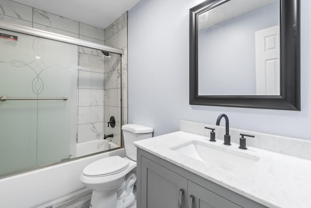 full bathroom with vanity, toilet, and enclosed tub / shower combo