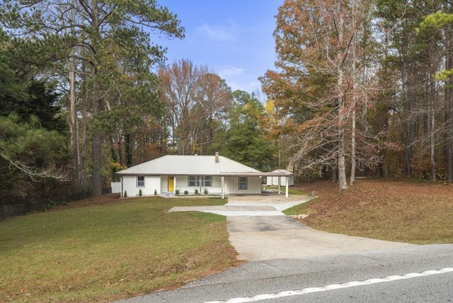 view of front facade with a front lawn and a carport