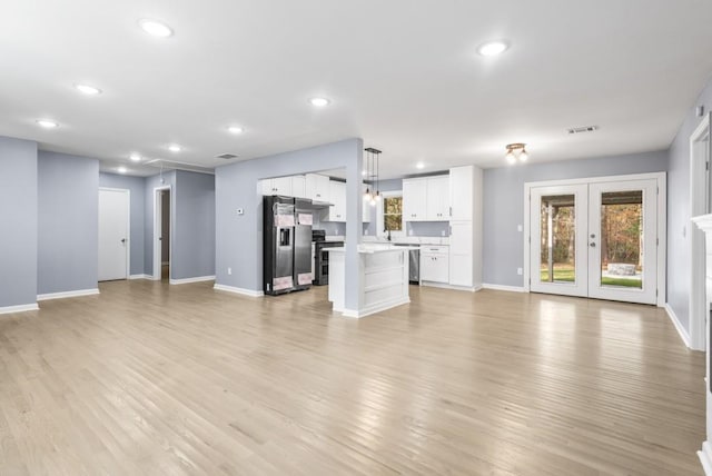 unfurnished living room with french doors, light hardwood / wood-style flooring, and sink