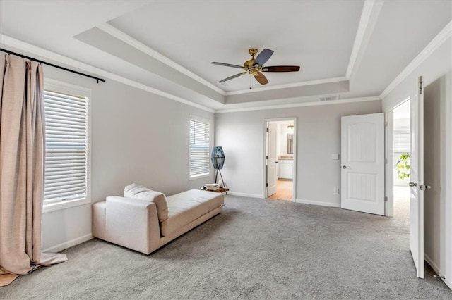 living area featuring visible vents, a raised ceiling, and light carpet