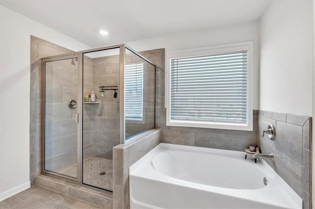 full bathroom with recessed lighting, a bath, a shower stall, and tile patterned flooring