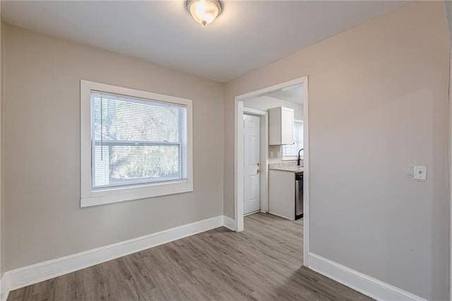 empty room featuring wood finished floors and baseboards