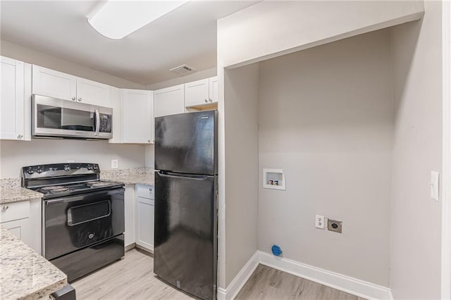 kitchen featuring visible vents, light wood-style floors, white cabinetry, light stone countertops, and black appliances