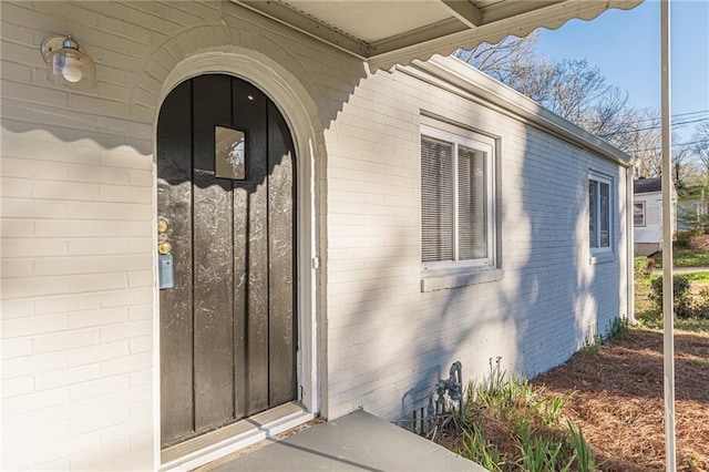 property entrance featuring brick siding