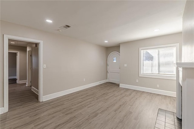 unfurnished living room with light wood-style floors, recessed lighting, visible vents, and baseboards