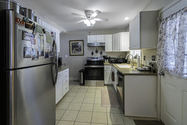 kitchen featuring light tile patterned flooring, appliances with stainless steel finishes, white cabinetry, sink, and ceiling fan