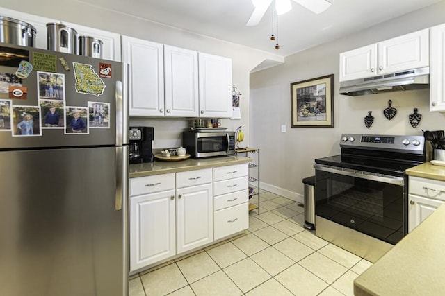 kitchen with ceiling fan, appliances with stainless steel finishes, light tile patterned floors, and white cabinets