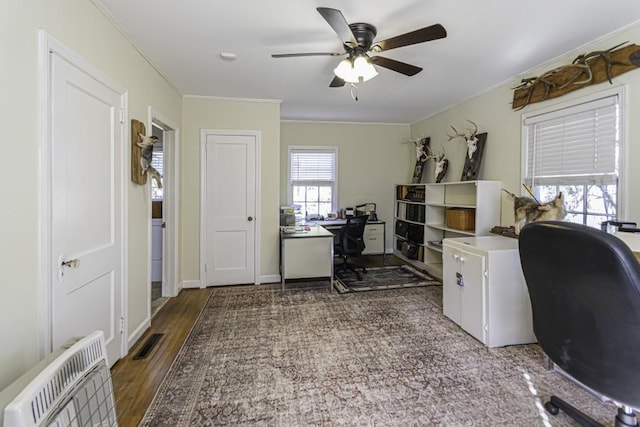 office area with crown molding, ceiling fan, wood-type flooring, and heating unit