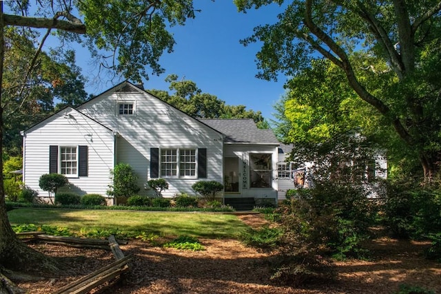 rear view of property featuring a yard