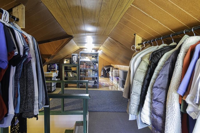 interior space featuring vaulted ceiling, wood ceiling, and wood walls