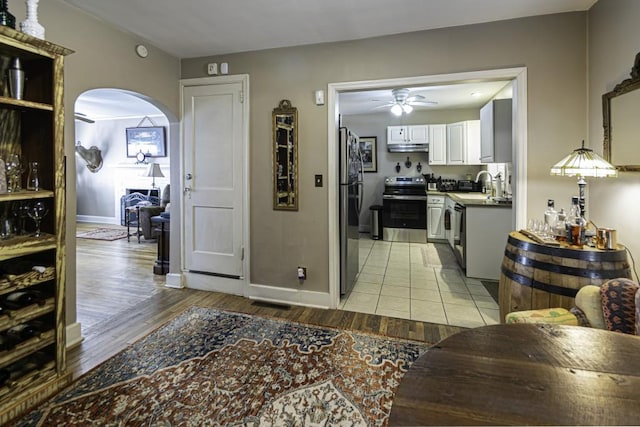 hallway with sink and light hardwood / wood-style flooring