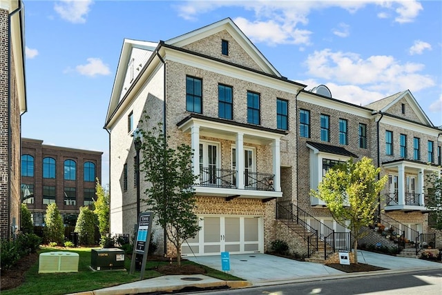 235 Briscoe Way Unit 7, Alpharetta, GA 30009 - view of property with concrete driveway, a garage, central AC unit, and brick siding