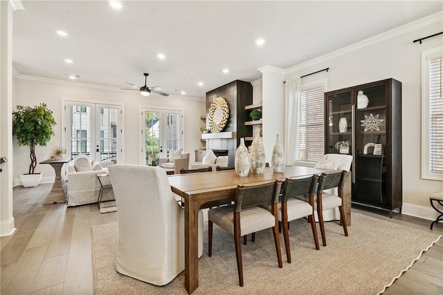 235 Briscoe Way Unit 7, Alpharetta, GA 30009 - dining area featuring baseboards, light wood-style floors, ceiling fan, and crown molding