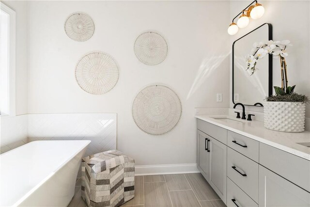 235 Briscoe Way Unit 7, Alpharetta, GA 30009 - bathroom with a freestanding tub, baseboards, and vanity