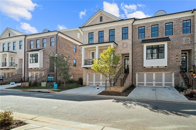 235 Briscoe Way Unit 7, Alpharetta, GA 30009 - townhome / multi-family property with stairs, brick siding, an attached garage, and driveway