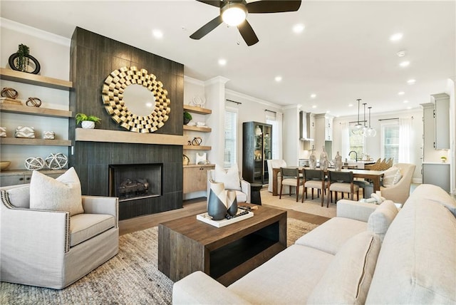 235 Briscoe Way Unit 7, Alpharetta, GA 30009 - living room featuring a tiled fireplace, recessed lighting, a ceiling fan, and ornamental molding