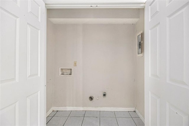 clothes washing area featuring gas dryer hookup, light tile patterned flooring, laundry area, washer hookup, and baseboards