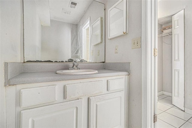 bathroom featuring vanity, visible vents, and tile patterned floors