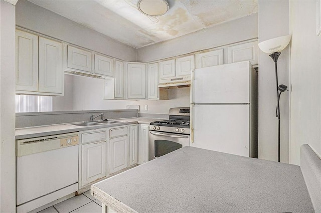 kitchen with light countertops, light tile patterned flooring, a sink, white appliances, and under cabinet range hood