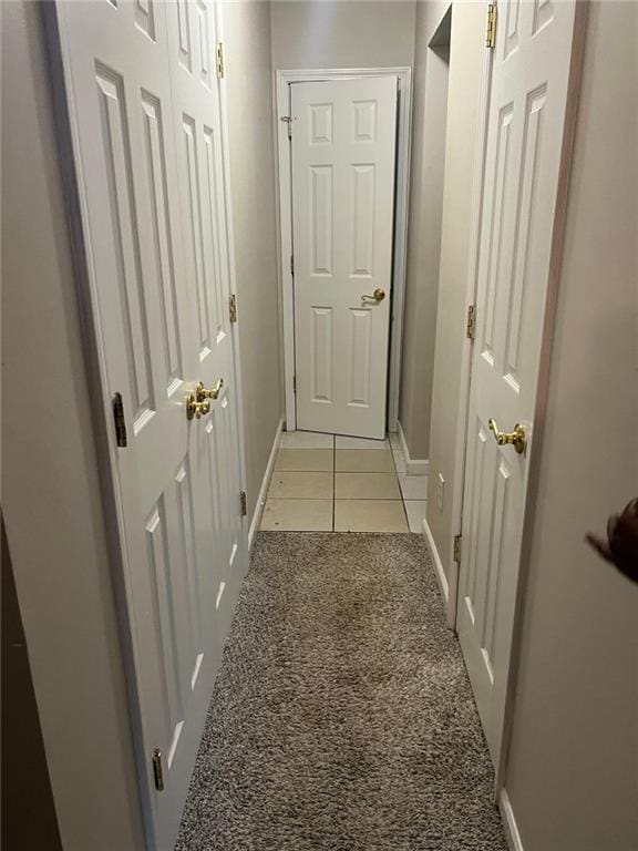 hallway with light colored carpet