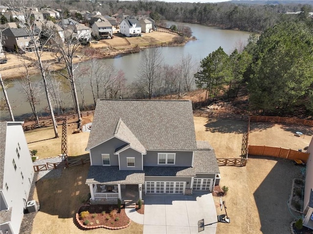 birds eye view of property featuring a water view and a residential view