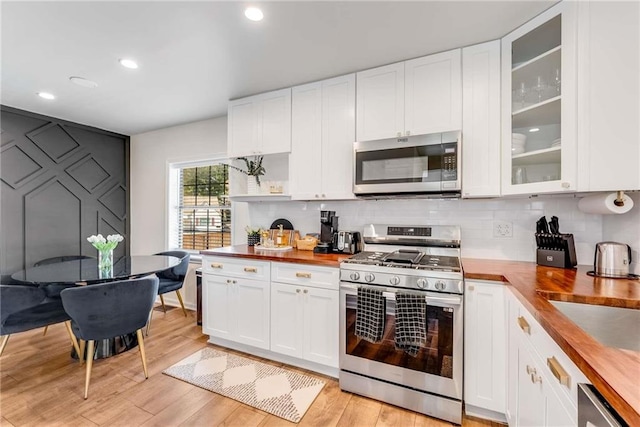 1471 Hardin Dr, College Park, GA 30337 - kitchen with appliances with stainless steel finishes, wood counters, light wood-type flooring, white cabinets, and recessed lighting