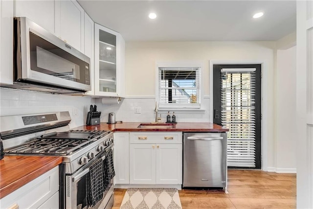 1471 Hardin Dr, College Park, GA 30337 - kitchen featuring stainless steel appliances, butcher block counters, light wood-style flooring, glass insert cabinets, and recessed lighting