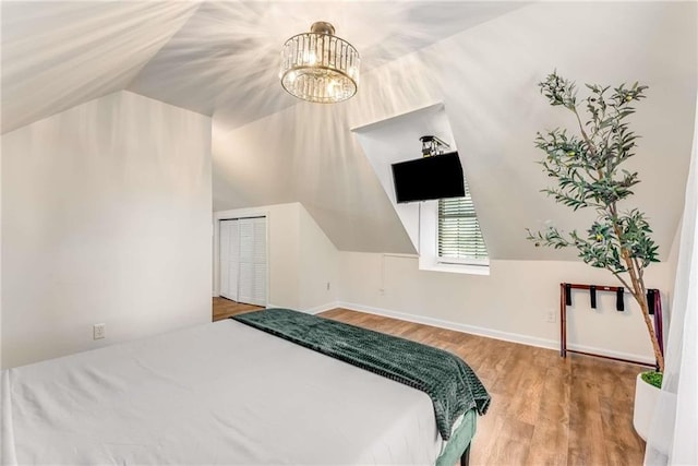 1471 Hardin Dr, College Park, GA 30337 - bedroom with wood finished floors, lofted ceiling, a chandelier, and a closet