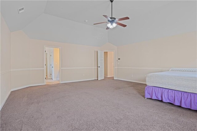 unfurnished bedroom with lofted ceiling and carpet