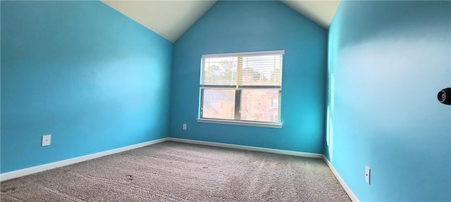 spare room with lofted ceiling and carpet flooring