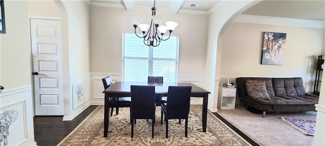 dining area with an inviting chandelier, ornamental molding, dark hardwood / wood-style floors, and beam ceiling