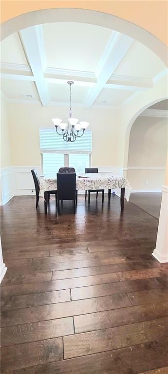 dining area with beam ceiling, coffered ceiling, and dark hardwood / wood-style flooring