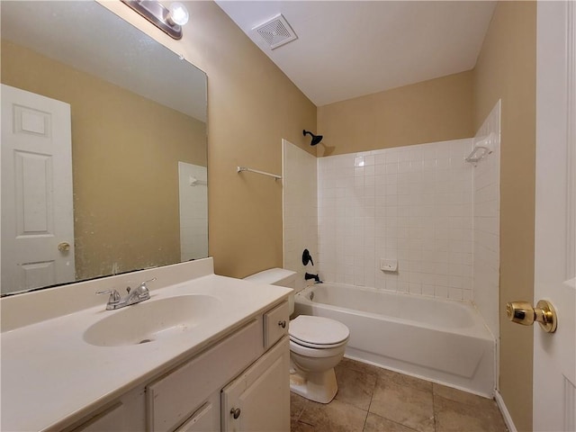 full bathroom featuring tiled shower / bath, vanity, toilet, and tile patterned flooring