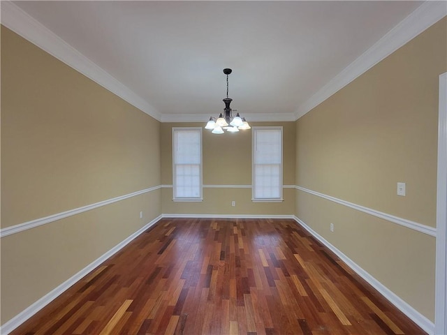 empty room featuring a notable chandelier, ornamental molding, and dark hardwood / wood-style floors