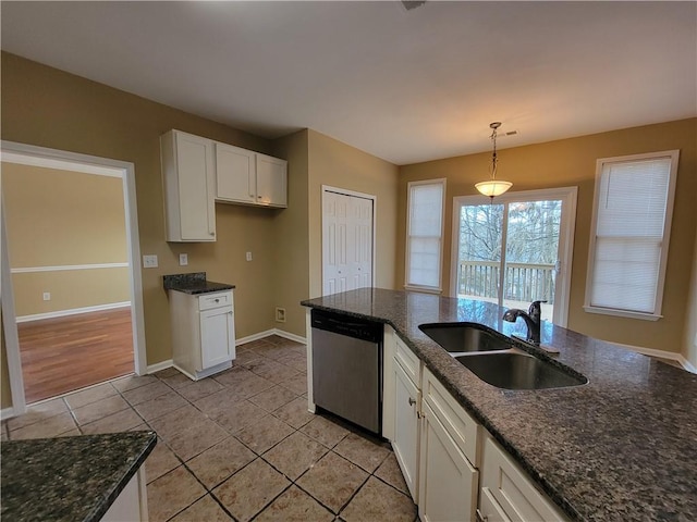 kitchen featuring sink, decorative light fixtures, stainless steel dishwasher, dark stone counters, and white cabinets