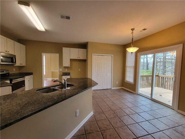 kitchen with white cabinetry, sink, stainless steel appliances, and hanging light fixtures