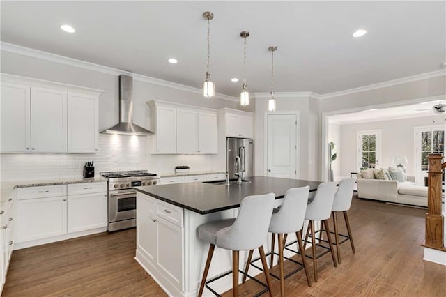 kitchen featuring a kitchen breakfast bar, high end appliances, wall chimney exhaust hood, and dark wood-style floors