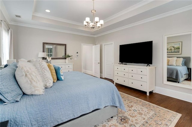 bedroom featuring visible vents, dark wood-type flooring, a notable chandelier, crown molding, and a raised ceiling