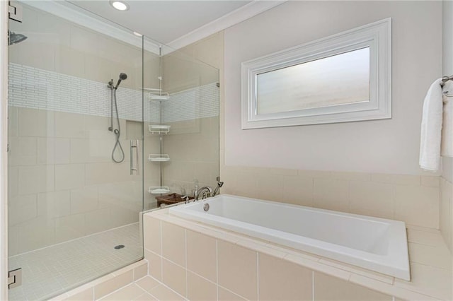 bathroom featuring a garden tub, a stall shower, and ornamental molding