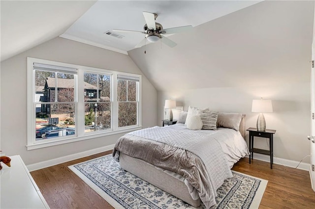 bedroom featuring visible vents, ceiling fan, baseboards, lofted ceiling, and wood finished floors