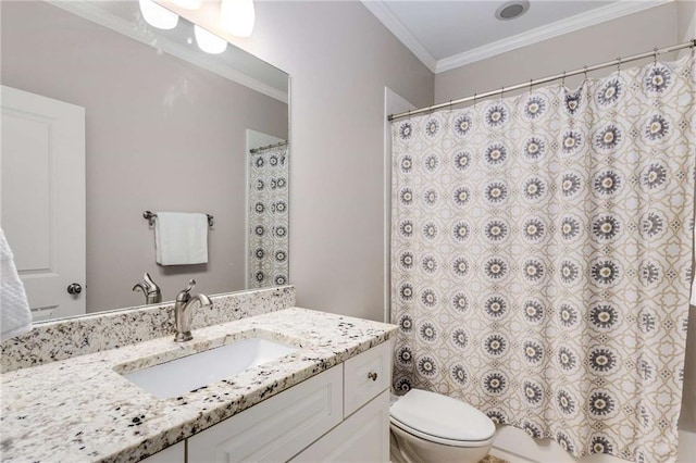 bathroom with vanity, crown molding, and toilet