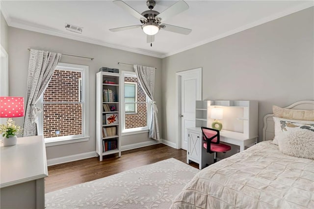 bedroom with multiple windows, baseboards, wood finished floors, and ornamental molding