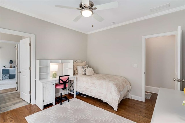 bedroom featuring wood finished floors and ornamental molding