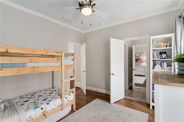 bedroom featuring visible vents, ornamental molding, and wood finished floors