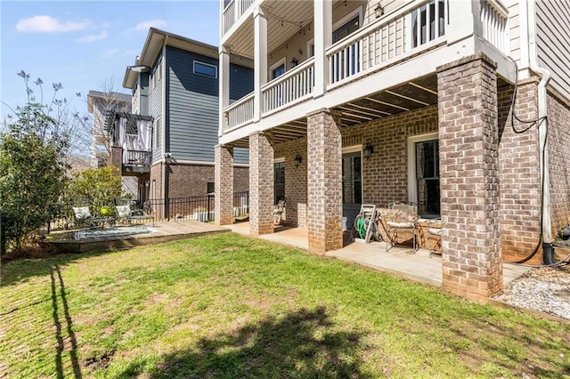 view of yard featuring a balcony and a patio