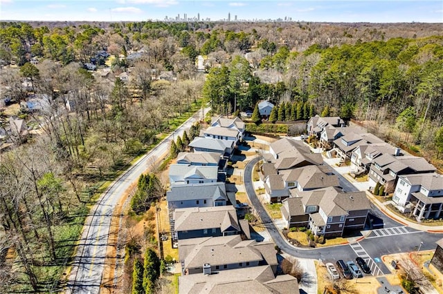 drone / aerial view with a residential view and a wooded view