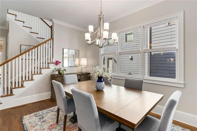 dining space featuring stairs, wood finished floors, baseboards, and ornamental molding